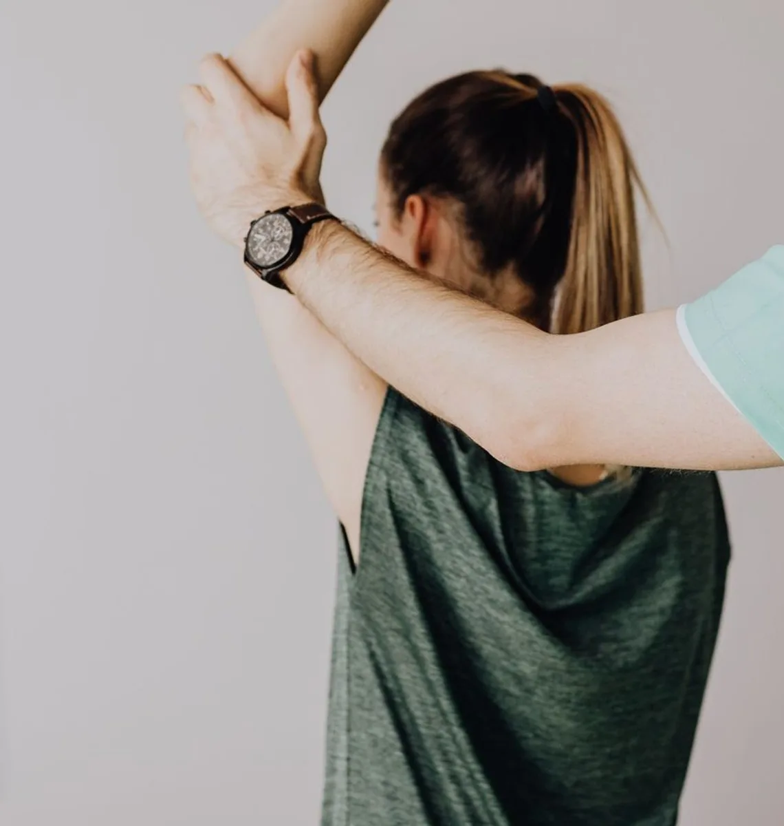 Physiotherapist guiding a shoulder and upper-back stretch