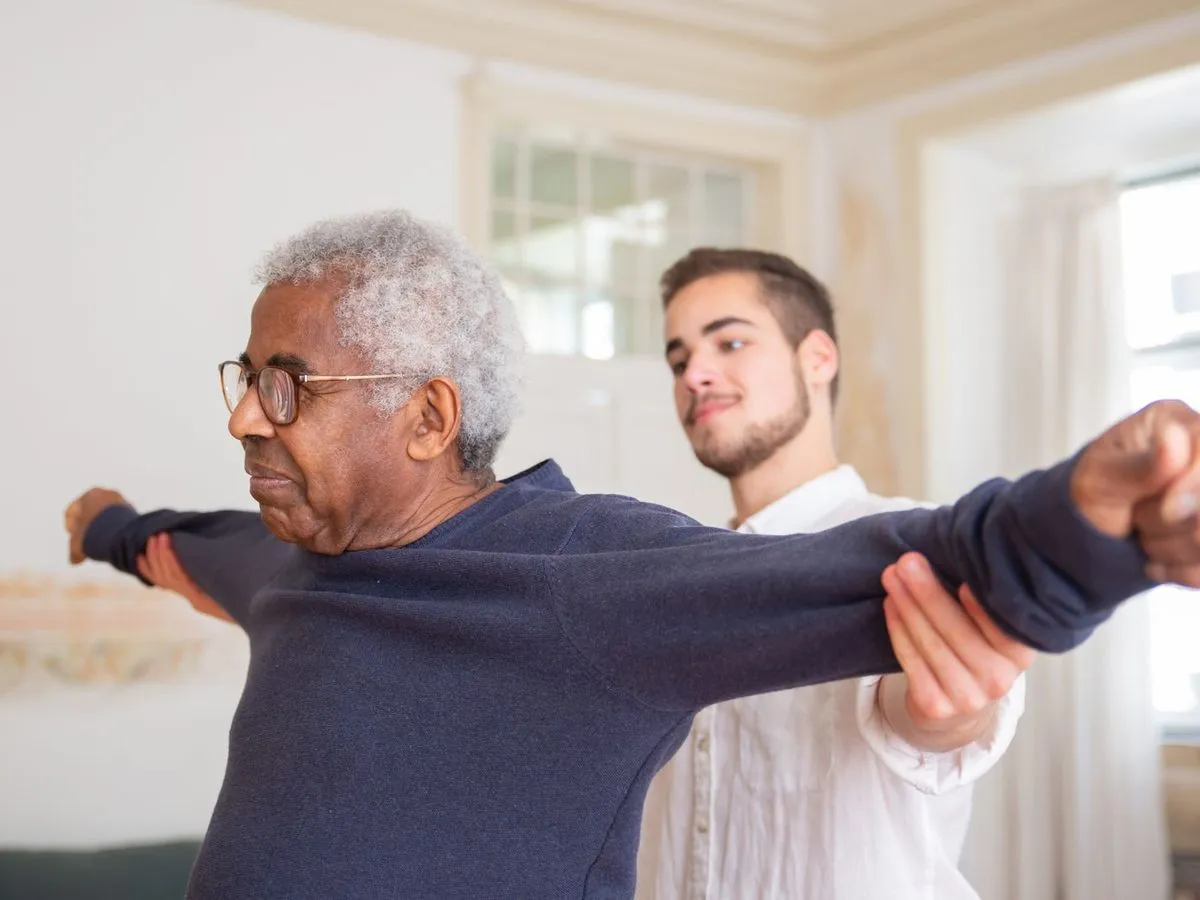 Physiotherapist helping an older man with an arm stretch