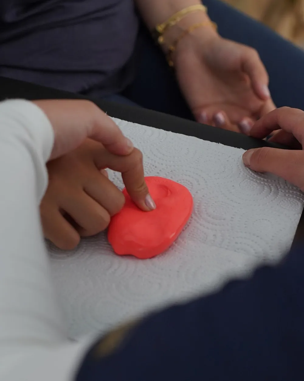 Hands working therapy putty during an occupational therapy session